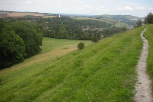 Looking back over Kingston village with Lewes in the distance. The new windmill can be seen in the middle of the photograph. Photograph taken at (C)