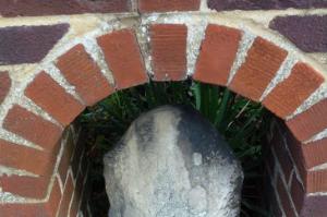 Old milestone set into brick wall outside Jack Stevens Close
