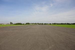 Looking along the runway (from the western end), with the playing fields on the left.
