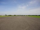 Looking along the runway (from the western end), with the playing fields on the left.