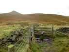 Looking towards Shutlingsloe from the stile on Buxtor Hill. Over the stile and straight on for the easier route - expect a steep drop if you turn right this side of the wall.
