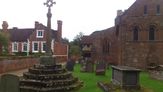 The Saxon preaching cross with Berkswell church and the Well House behind.