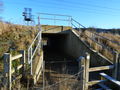 Under the railway bridge.