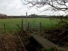 Photo 15 - On leaving the road, the footpath immediately crosses a concrete plank bridge, goes through a metal kissing gate, then across the field to the church.