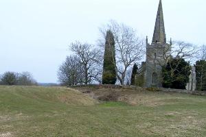 Elmley Lovett Church and the site of the medieval village. The raised platform on the left was the former site of a moated manor house.