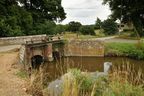 (E) Sluice Gates controlling the water level at the Mill Farm  Pond. The field behind to your left was once the site of a mediaeval ironworks.