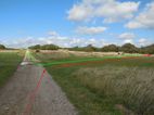 Looking along the South Downs Way at point [2]. Green indicates the outward route, red the return route both passing in front of the brick seat.