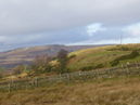 Looking back towards Longshaw from near the A625 with Higger Tor and Stanage Edge in the distance. The Wooden Pole can be seen on the right.
